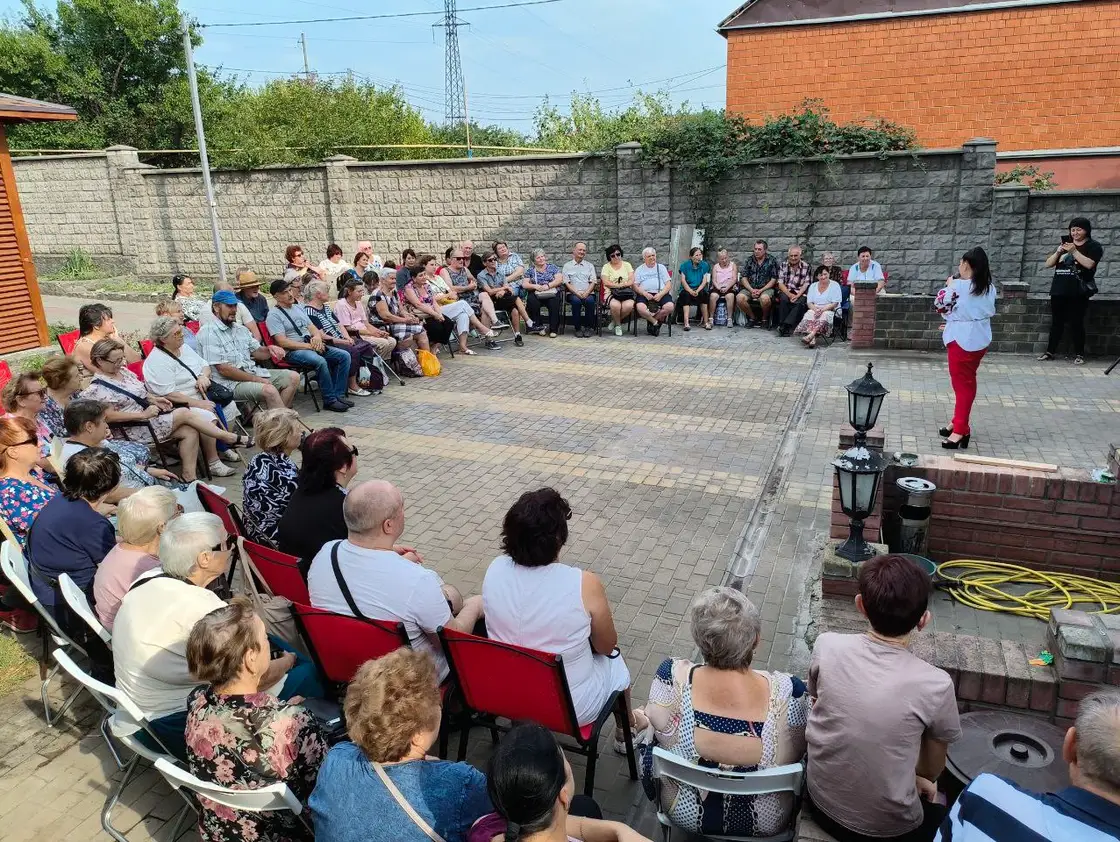 Концерт у дворі: глядачі на стільцях півколом